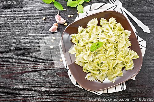 Image of Farfalle with pesto in plate on board top