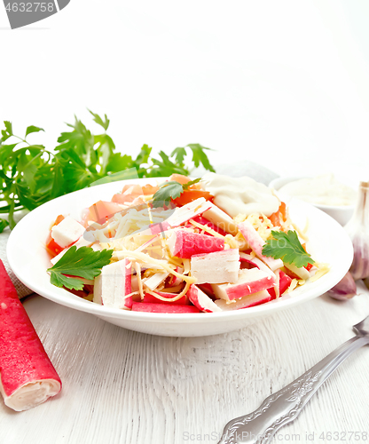 Image of Salad of surimi and tomatoes on light table