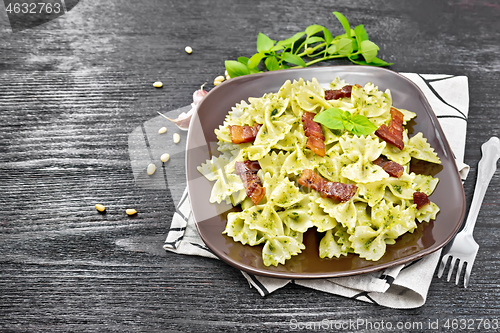 Image of Farfalle with pesto and bacon on board