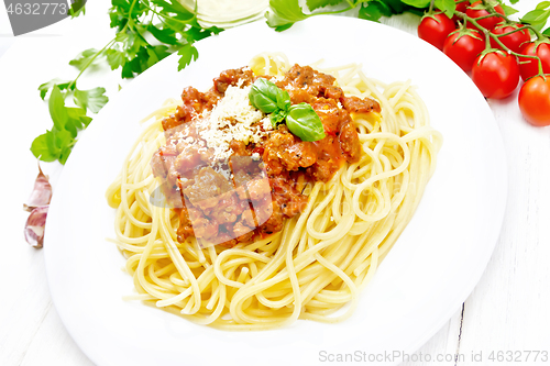 Image of Spaghetti with bolognese on white wooden board