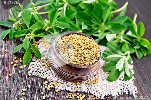 Image of Fenugreek in bowl with leaves on dark board