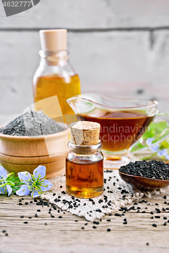 Image of Oil kalingi in bottles and gravy boat on wooden board