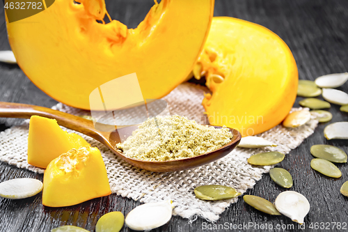 Image of Flour pumpkin in spoon on dark board