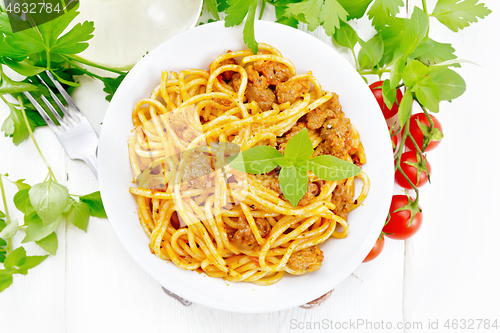 Image of Spaghetti with bolognese in plate on light board top