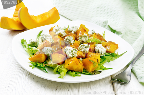 Image of Salad of pumpkin and cheese in plate on board