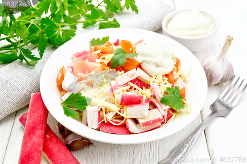 Image of Salad of surimi and tomatoes on table