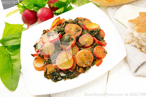 Image of Radish with spinach and spices in plate on wooden board