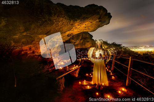 Image of Praying angle surrounded by tea light candles