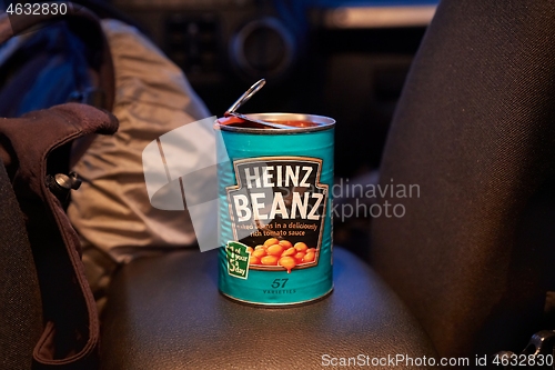 Image of Can of beans open on the back seat of a car