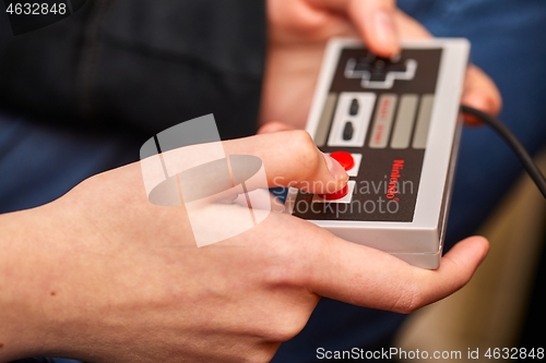 Image of Nintengo NES,playing Super Mario 3