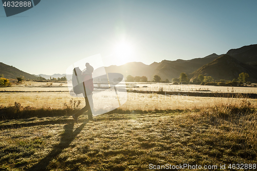 Image of Woman walking with a backpack