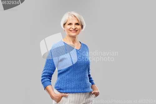 Image of portrait of smiling senior woman in blue sweater