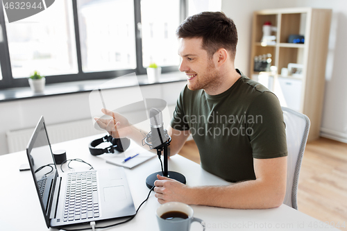 Image of blogger with laptop and microphone audio blogging