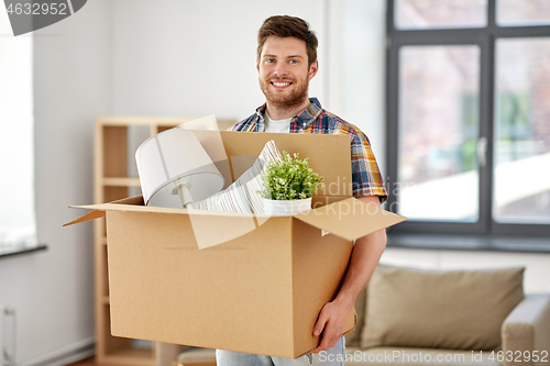 Image of happy man with box moving to new home