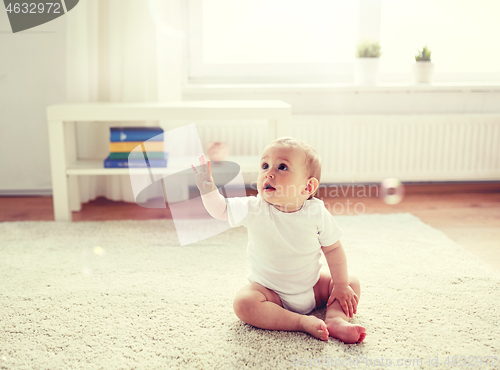 Image of happy baby with soap bubbles at home