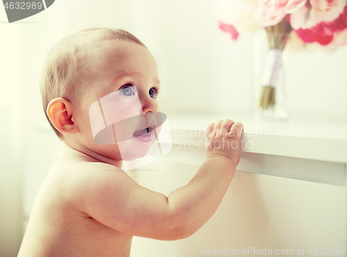 Image of happy little baby boy or girl at home