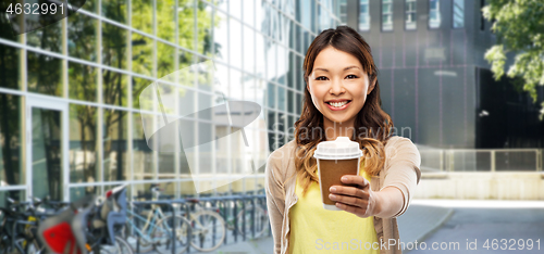 Image of happy asian woman with coffee on city street