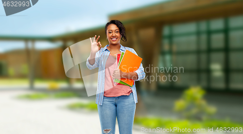 Image of african american student woman with notebooks