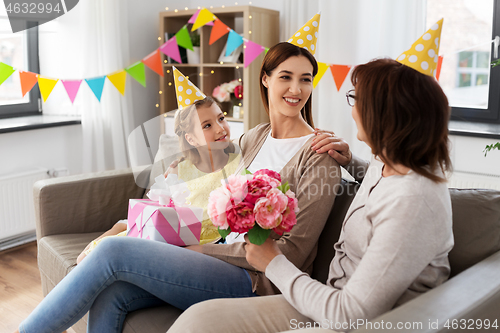 Image of grandmother greeting mother on birthday at home