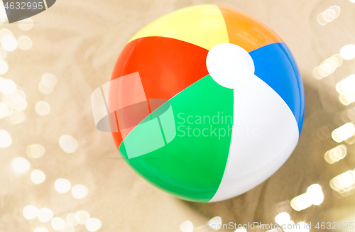 Image of close up of inflatable beach ball on sand