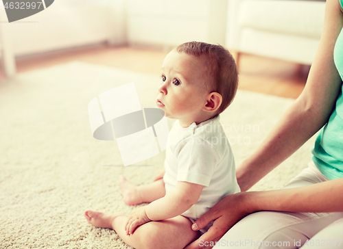 Image of little baby with mother at home