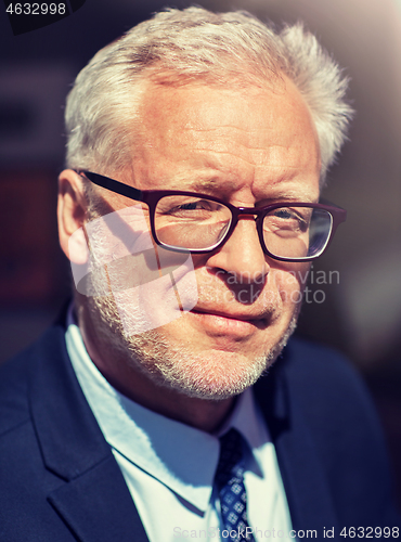 Image of close up of senior businessman in eyeglasses