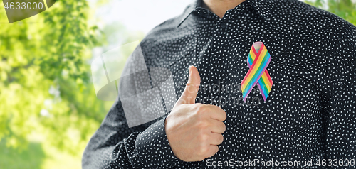 Image of man with gay pride rainbow awareness ribbon