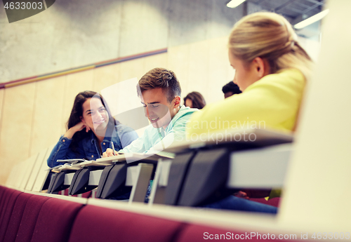 Image of group of students with notebooks at lecture hall