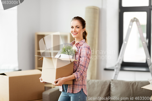 Image of happy woman with stuff moving to new home