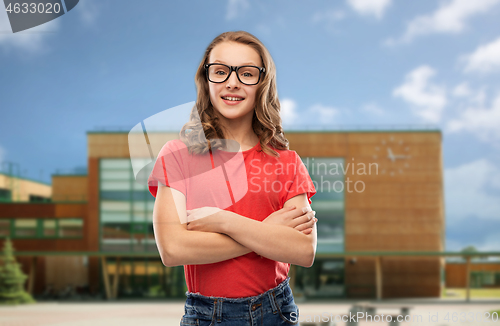 Image of smiling student girl in glasses over school