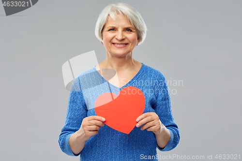 Image of smiling senior woman with red heart