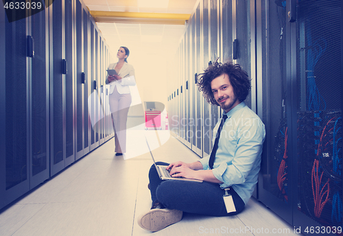 Image of Team of young technicians working together on servers