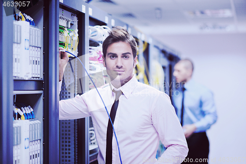 Image of it engineers in network server room