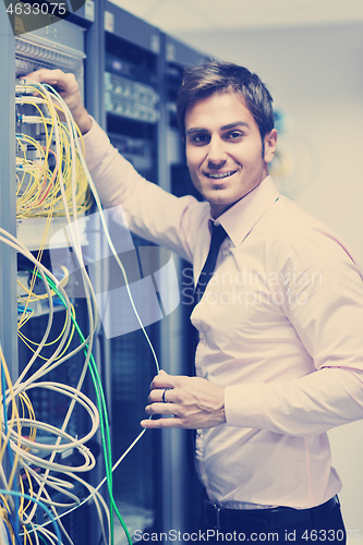 Image of young it engeneer in datacenter server room