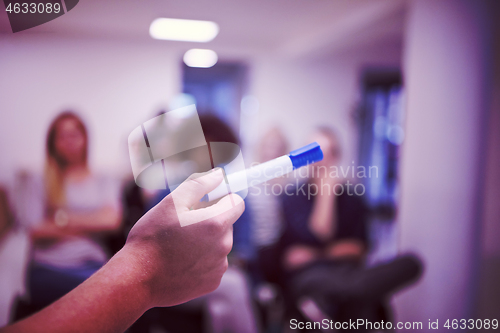 Image of close up of teacher hand with marker