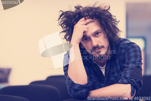 Image of A student sits alone  in a classroom