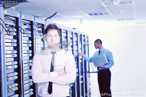 Image of it engineers in network server room