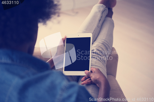 Image of african american woman at home with digital tablet