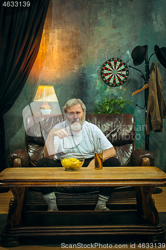 Image of The crazy football fan watching soccer game on television