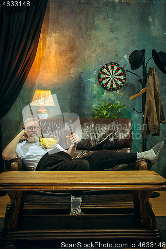 Image of The crazy football fan watching soccer game on television