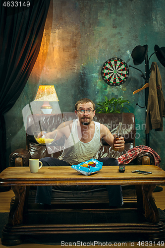 Image of The crazy football fan watching soccer game on television