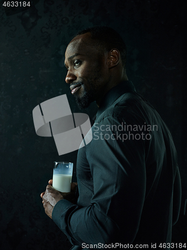 Image of Healthy young african man holging milk