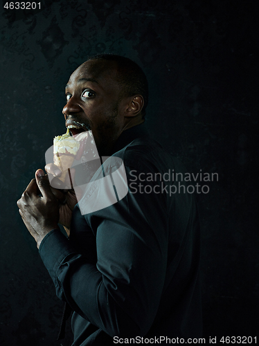 Image of Portrait of afro american man holding ice cream