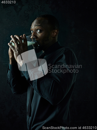 Image of Healthy young african man holging milk