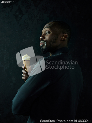 Image of Portrait of afro american man holding ice cream