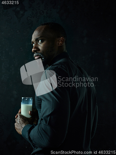 Image of Healthy young african man holging milk