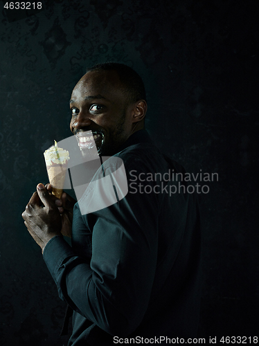 Image of Portrait of afro american man holding ice cream