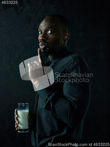 Image of Healthy young african man holging milk