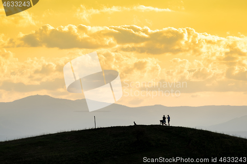 Image of a couple and the dog out for a walk