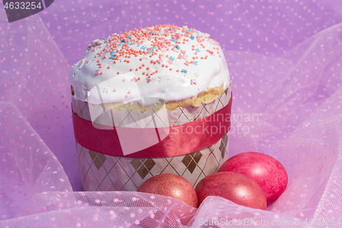 Image of Easter cake decorated with pink decor and rose-colored eggs